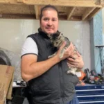 Professional pet grooming team members providing mobile grooming services to dogs